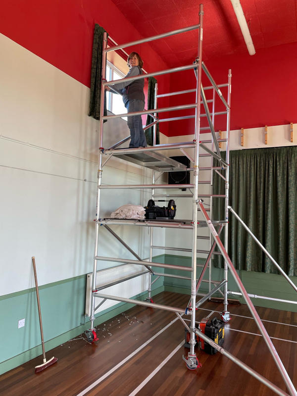Here Ruth is using our new safe scaffolding tower to rehang curtains